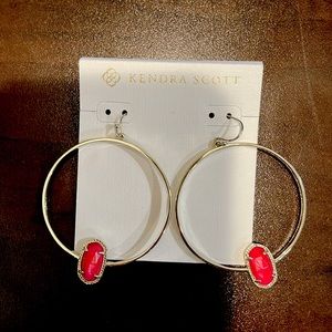 Kendra Scott Gold hoop earrings w with bright pinkish stone.